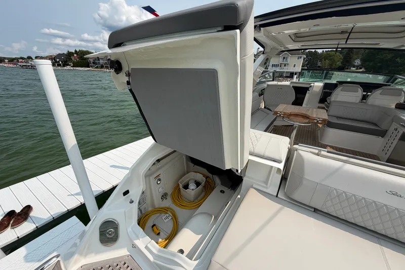 Slide: The Image of 2023 Sea Ray SLX 400 boat interior with open storage compartment and seating area. - 35