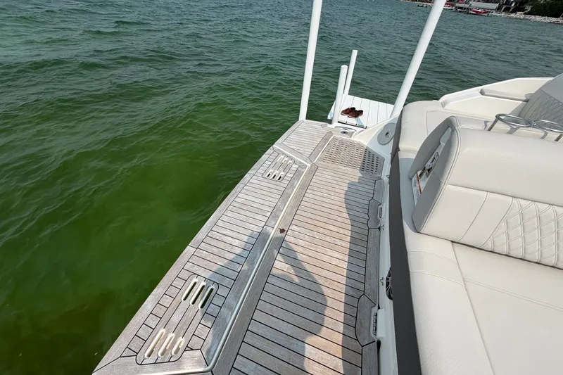 Slide: The Image of 2023 Sea Ray SLX 400 boat deck with luxurious seating and lake view. - 31