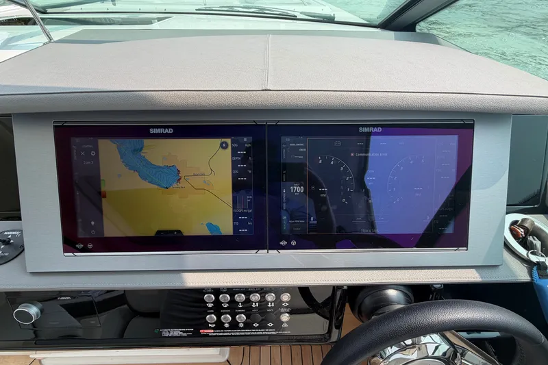 Slide: The Image of Dashboard of 2023 Sea Ray SLX 400 with dual Simrad displays showing navigation and controls. - 19