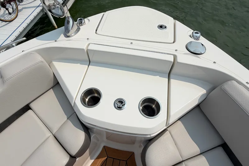 Slide: The Image of 2023 Sea Ray SLX 400 boat interior with cup holders and seating area. - 16