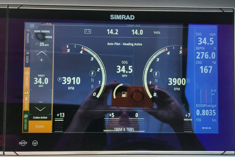 Slide: The Image of Simrad display on 2023 Sea Ray SLX 400 showing speed, RPM, and navigation data. - 20