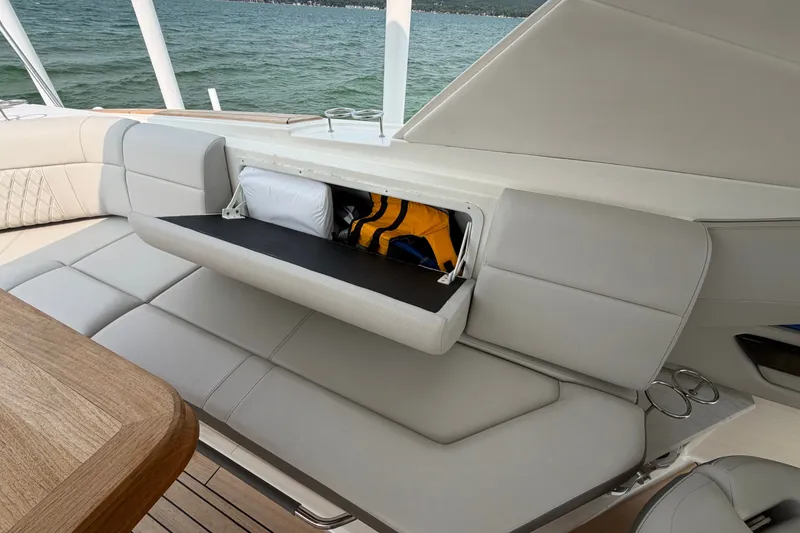 Slide: The Image of 2023 Sea Ray SLX 400 boat interior with open storage compartment and cushioned seating. - 29