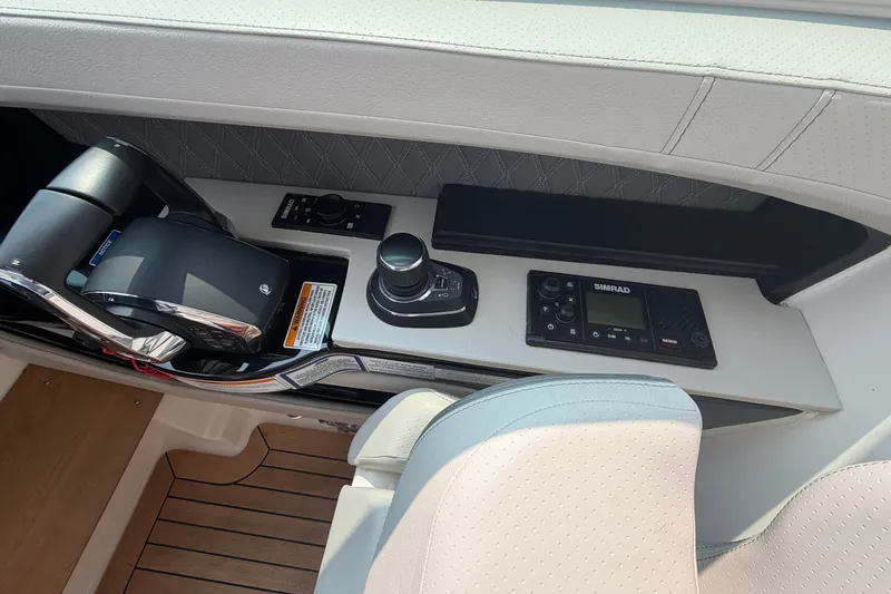Slide: The Image of 2023 Sea Ray SLX 400 helm controls with Simrad navigation system and joystick. - 21