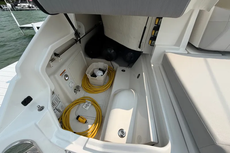 Slide: The Image of 2023 Sea Ray SLX 400 boat storage area with yellow cables and equipment. - 33