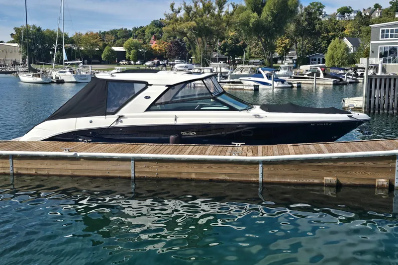 Slide: The Image of 2023 Sea Ray SLX 400 boat docked at a marina with scenic background. - 45