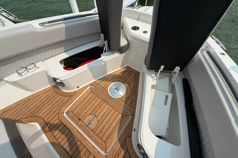 Slide: The Image of 2023 Sea Ray SLX 400 boat interior with teak flooring and storage compartments. - 15