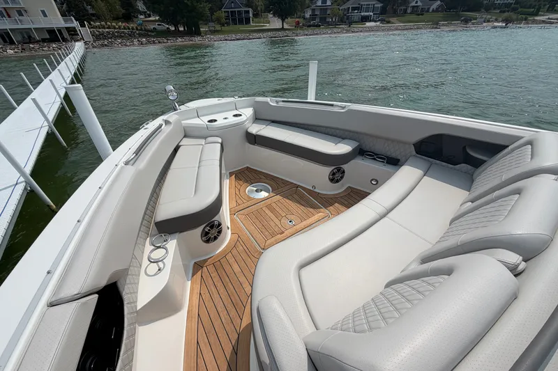 Slide: The Image of Luxurious seating area on 2023 Sea Ray SLX 400 boat with elegant wood flooring. - 14