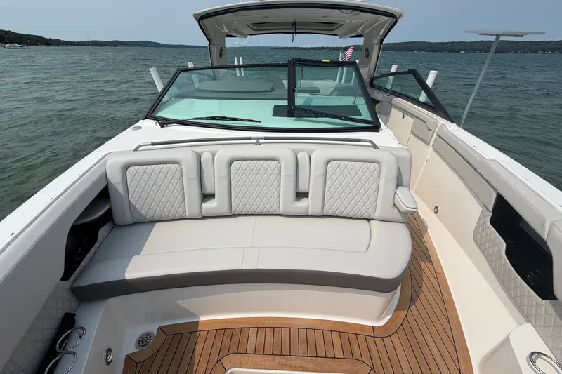 Slide: The Image of 2023 Sea Ray SLX 400 boat interior with luxurious seating and elegant design on open water. - 13
