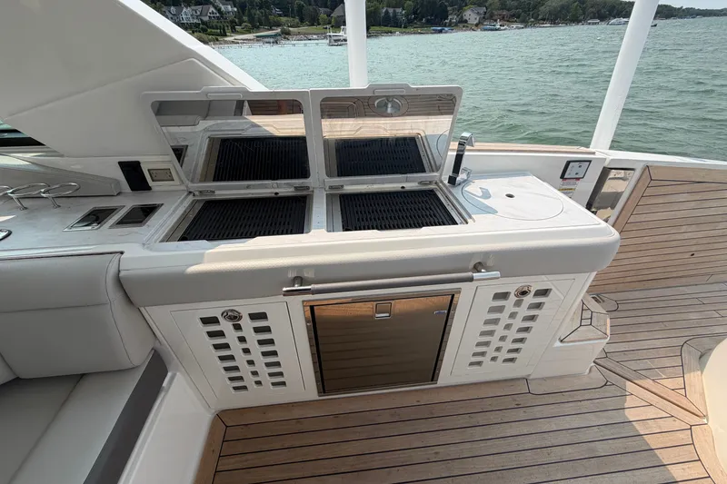 Slide: The Image of Outdoor kitchen on 2023 Sea Ray SLX 400 yacht with grill and sink, overlooking water. - 25
