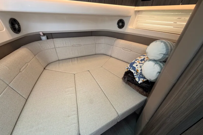 Slide: The Image of Luxurious interior of 2023 Sea Ray SLX 400 boat with plush seating and cozy pillows. - 36
