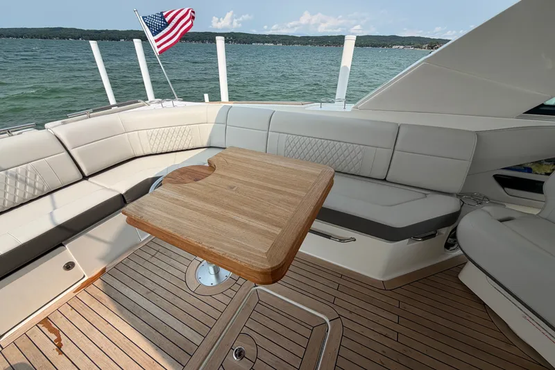 Slide: The Image of Luxurious 2023 Sea Ray SLX 400 yacht interior with elegant seating and wooden table. - 26