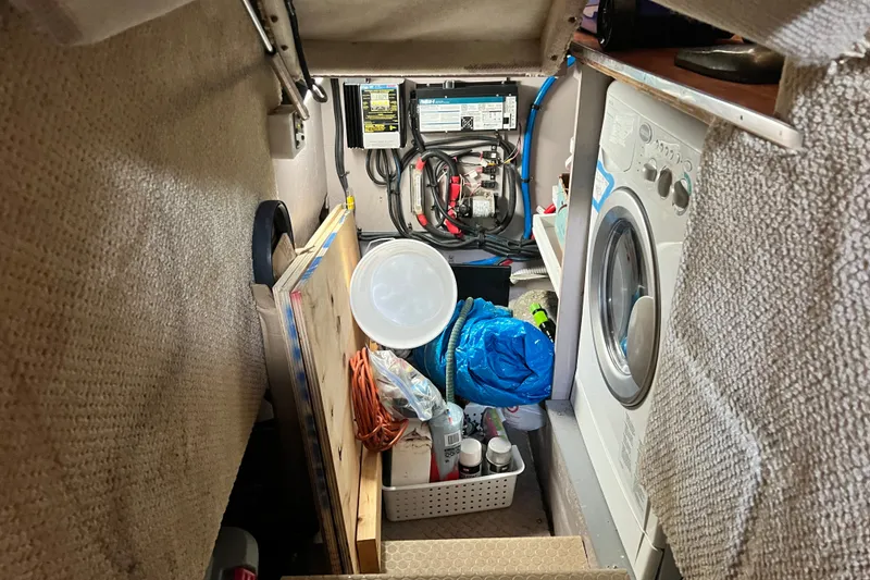 Slide: The Image of Laundry area in a 2003 Sea Ray 480 Motor Yacht with washer and storage. - 57