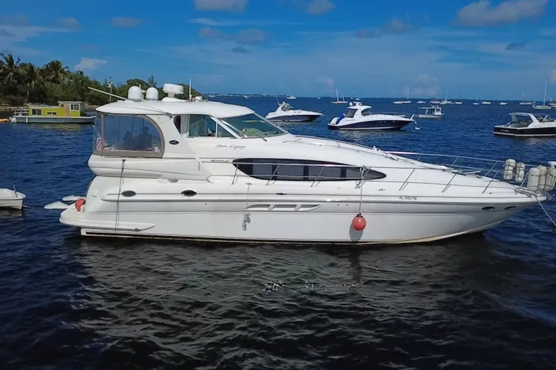 Slide: The Image of 2003 Sea Ray 480 Motor Yacht on calm water, surrounded by other boats. - 5