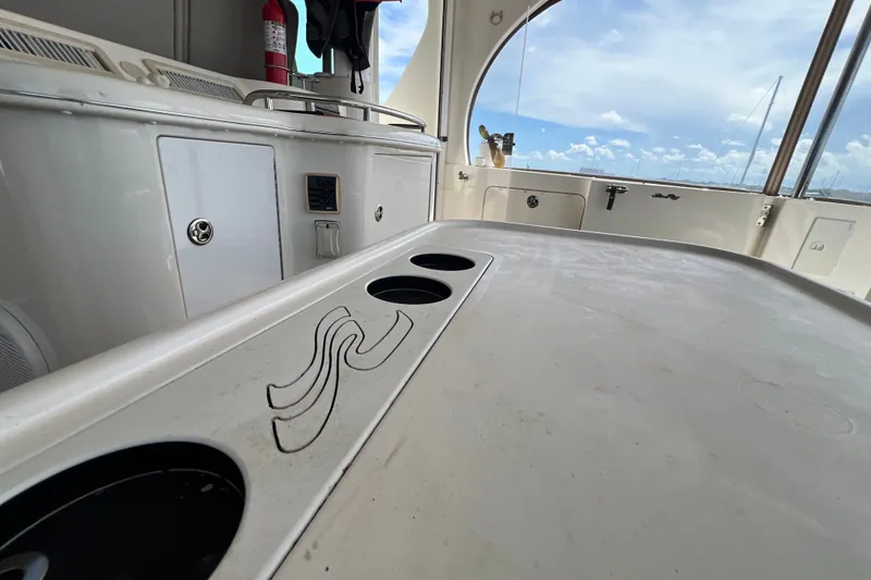 Slide: The Image of 2003 Sea Ray 480 Motor Yacht interior with counter and cup holders, featuring a scenic view. - 184