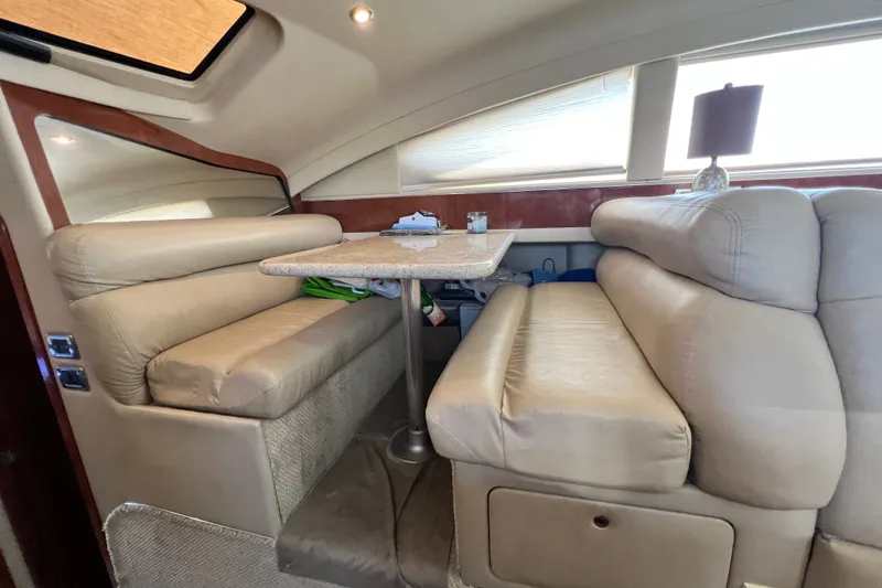 Slide: The Image of Interior of 2003 Sea Ray 480 Motor Yacht with beige leather seating and dining table. - 97