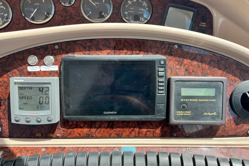 Slide: The Image of Control panel of a 2003 Sea Ray 480 Motor Yacht with navigation and monitoring systems. - 94
