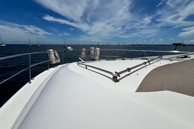 Slide: The Image of 2003 Sea Ray 480 Motor Yacht on open water under a clear blue sky. - 60
