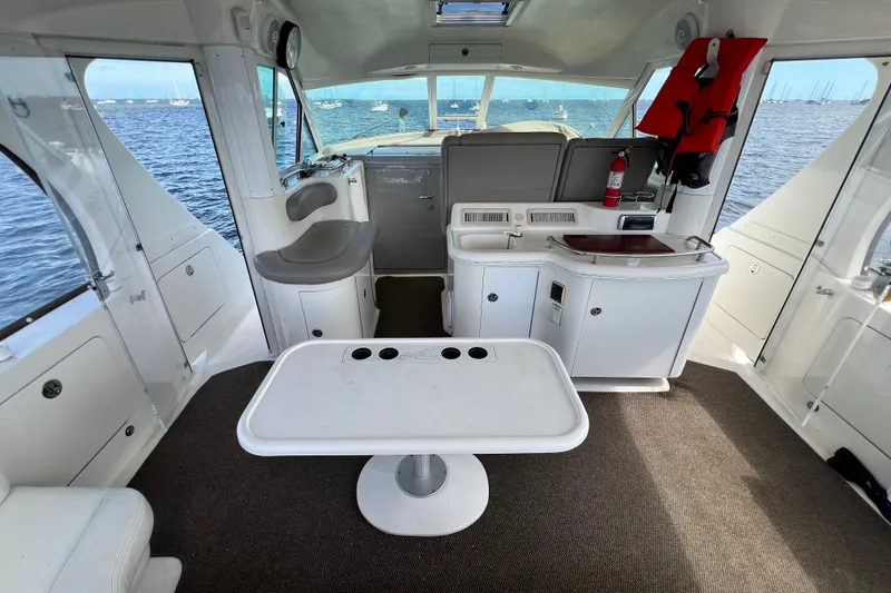 Slide: The Image of Interior of 2003 Sea Ray 480 Motor Yacht with seating, table, and ocean view. - 174