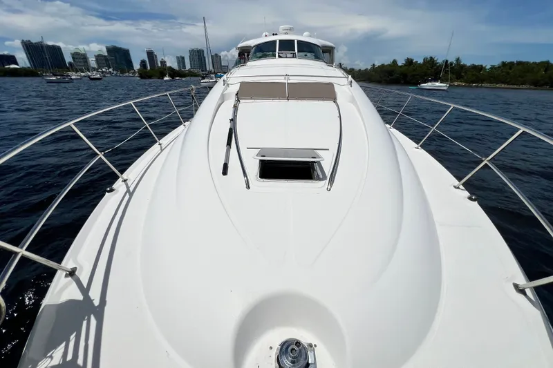 Slide: The Image of 2003 Sea Ray 480 Motor Yacht on water with city skyline in background. - 72