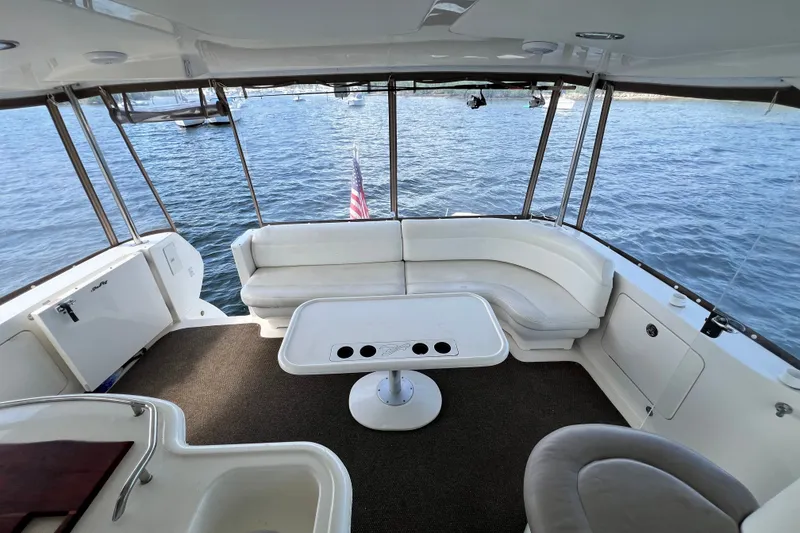 Slide: The Image of 2003 Sea Ray 480 Motor Yacht interior with seating and table, overlooking water. - 171