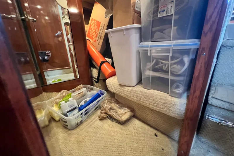 Slide: The Image of Storage area inside a 2003 Sea Ray 480 Motor Yacht with various containers and supplies. - 121