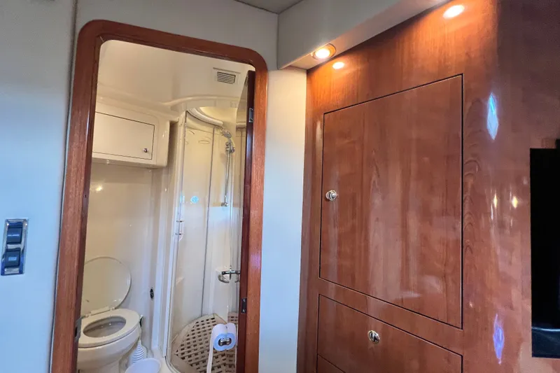 Slide: The Image of Interior of 2003 Sea Ray 480 Motor Yacht featuring bathroom and wooden cabinetry. - 109