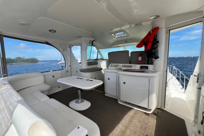 Slide: The Image of 2003 Sea Ray 480 Motor Yacht interior with seating, table, and ocean view. - 176