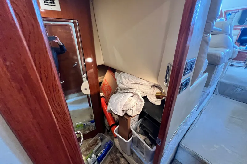 Slide: The Image of Interior storage area of a 2003 Sea Ray 480 Motor Yacht, featuring various items and supplies. - 122
