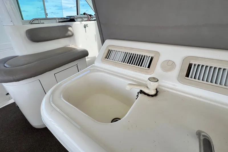 Slide: The Image of 2003 Sea Ray 480 Motor Yacht interior with sink and seating area. - 179