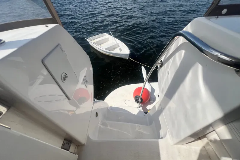 Slide: The Image of 2003 Sea Ray 480 Motor Yacht with dinghy on calm water. - 194