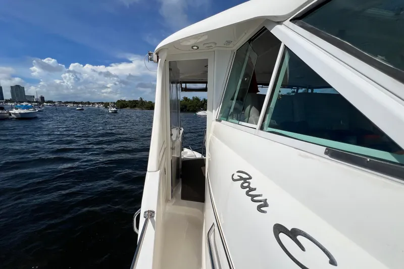 Slide: The Image of 2003 Sea Ray 480 Motor Yacht on water, sunny day, city skyline in background. - 189
