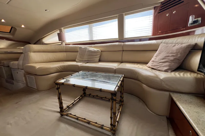 Slide: The Image of Luxurious interior of 2003 Sea Ray 480 Motor Yacht with plush seating and glass table. - 156