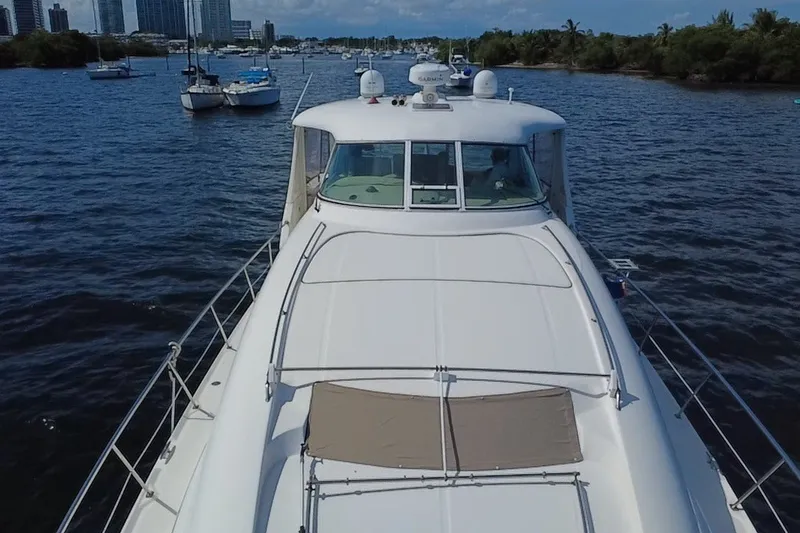 Slide: The Image of 2003 Sea Ray 480 Motor Yacht cruising on a scenic waterway with city skyline. - 202