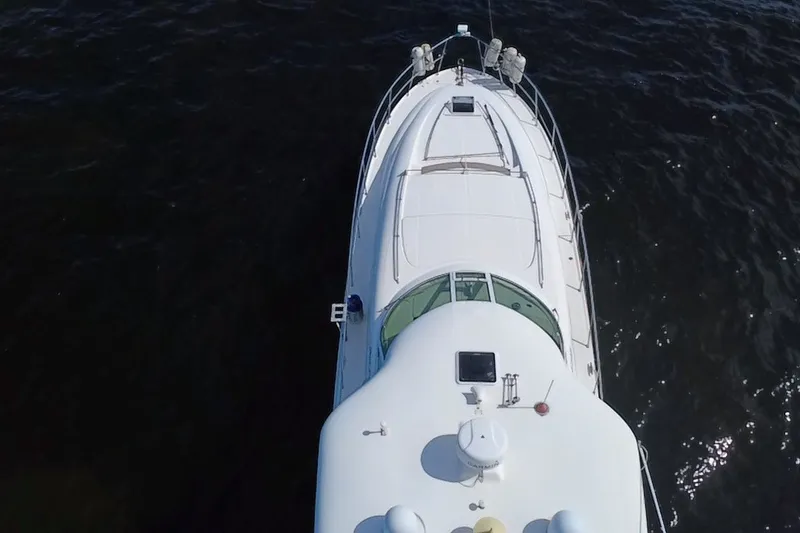 Slide: The Image of Aerial view of 2003 Sea Ray 480 Motor Yacht on dark water. - 214
