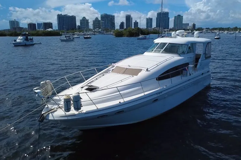 Slide: The Image of 2003 Sea Ray 480 Motor Yacht on water with city skyline in background. - 3