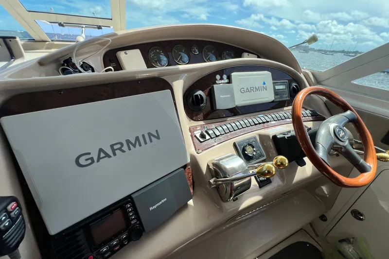 Slide: The Image of 2003 Sea Ray 480 Motor Yacht helm with Garmin navigation system and wooden steering wheel. - 163