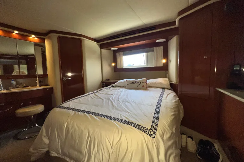 Slide: The Image of Luxurious bedroom interior of 2003 Sea Ray 480 Motor Yacht with elegant wood finishes. - 141