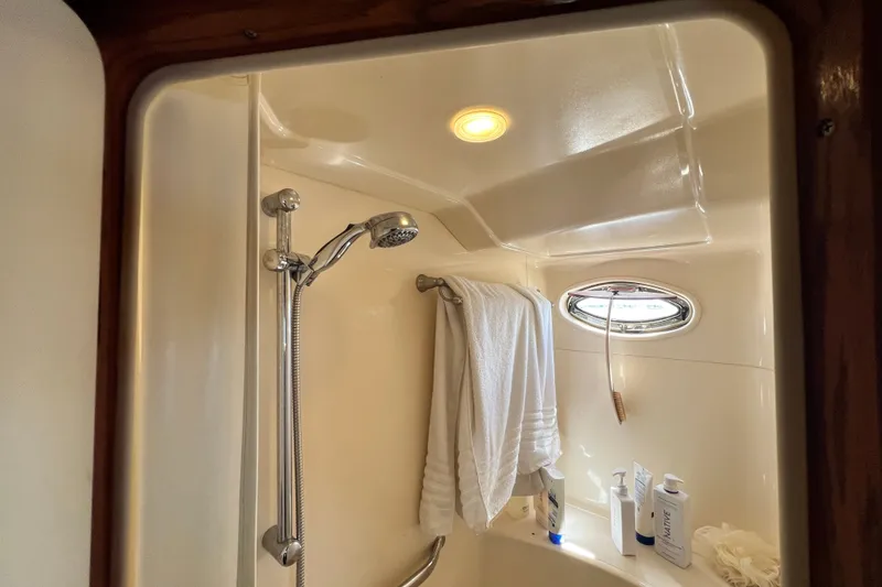 Slide: The Image of Shower area in 2003 Sea Ray 480 Motor Yacht with towel and toiletries. - 135