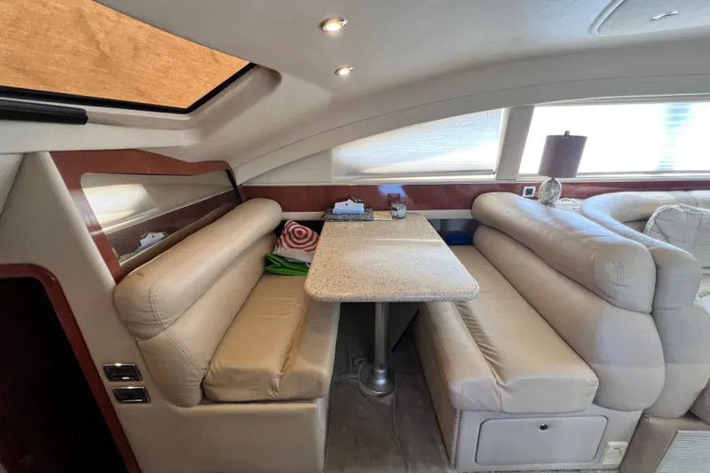 Slide: The Image of Luxurious interior of 2003 Sea Ray 480 Motor Yacht with plush seating and elegant table. - 98