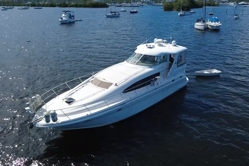 Slide: The Image of 2003 Sea Ray 480 Motor Yacht on calm waters, surrounded by other boats. - 12