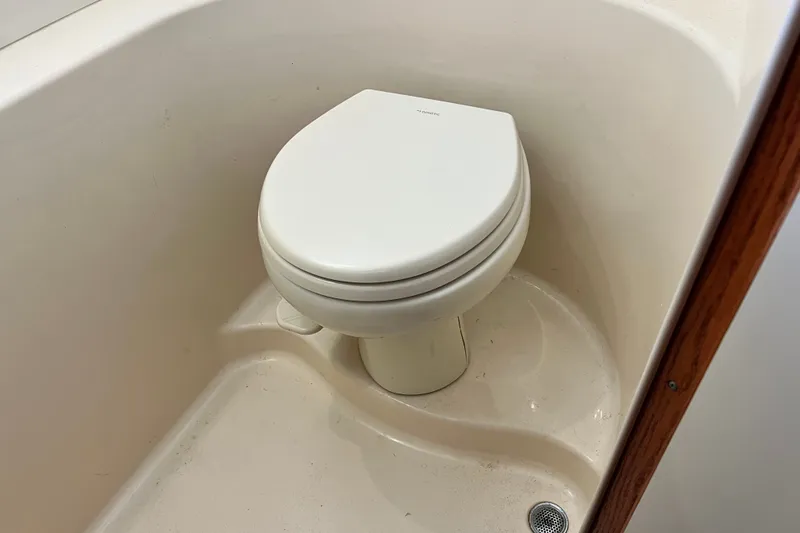 Slide: The Image of Toilet in 2003 Sea Ray 480 Motor Yacht bathroom, featuring compact design and white finish. - 130