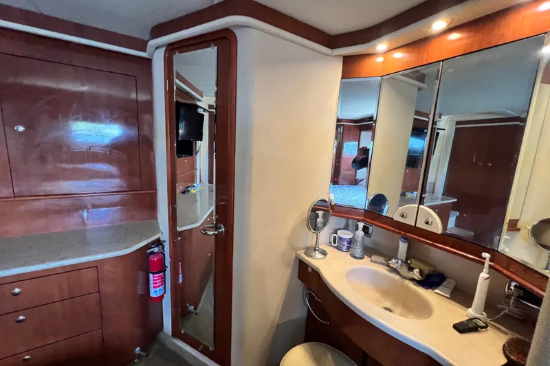 Slide: The Image of Luxurious bathroom interior of 2003 Sea Ray 480 Motor Yacht with wooden cabinetry and vanity. - 138