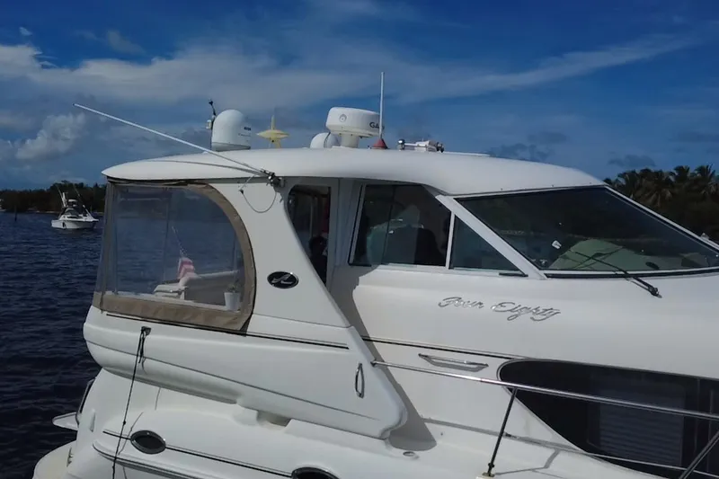 Slide: The Image of 2003 Sea Ray 480 Motor Yacht on water, clear sky background. - 203