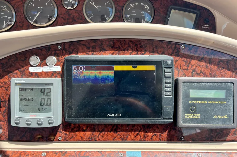 Slide: The Image of Dashboard of a 2003 Sea Ray 480 Motor Yacht with navigation and monitoring systems. - 95