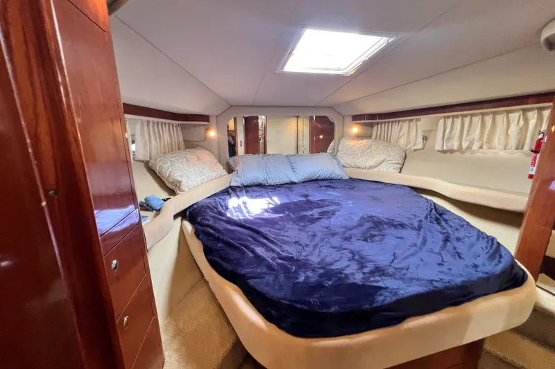 Slide: The Image of Luxurious bedroom interior of 2003 Sea Ray 480 Motor Yacht with plush bedding. - 123