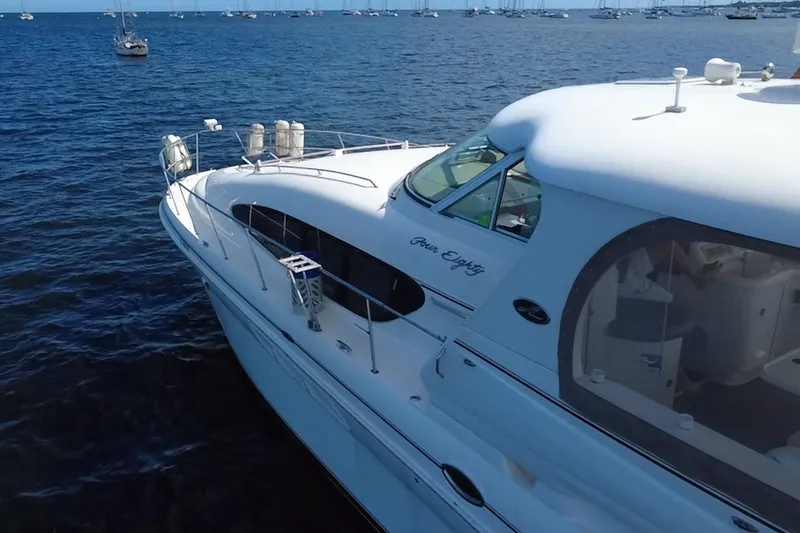 Slide: The Image of 2003 Sea Ray 480 Motor Yacht on calm blue waters, showcasing sleek design and luxury. - 211