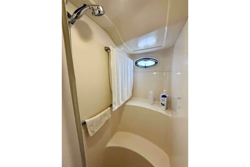 Slide: The Image of Shower area in 2003 Sea Ray 480 Motor Yacht with towel and toiletries. - 17