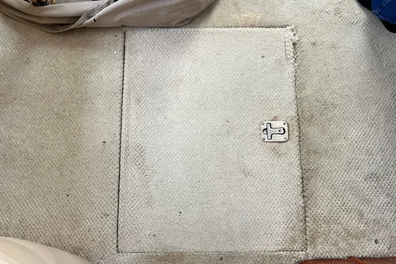 Slide: The Image of Carpeted hatch on 2003 Sea Ray 480 Motor Yacht floor with metal latch. - 53