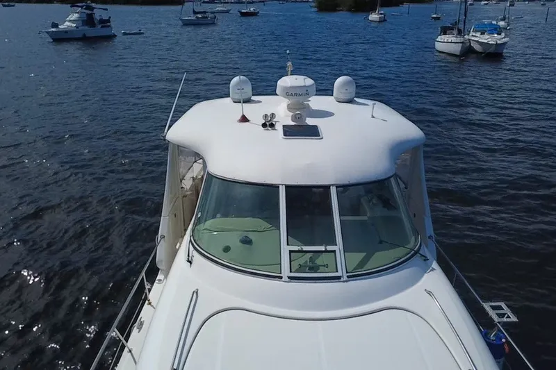 Slide: The Image of 2003 Sea Ray 480 Motor Yacht on calm waters, surrounded by other boats. - 205