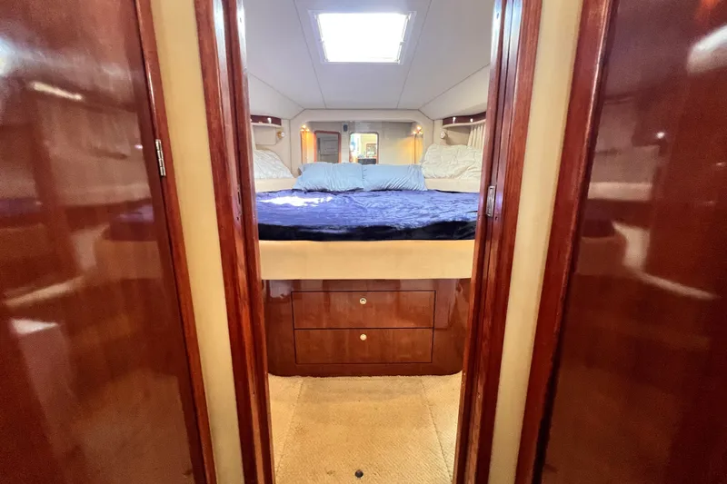 Slide: The Image of Luxurious 2003 Sea Ray 480 Motor Yacht bedroom with elegant wood finishes. - 102